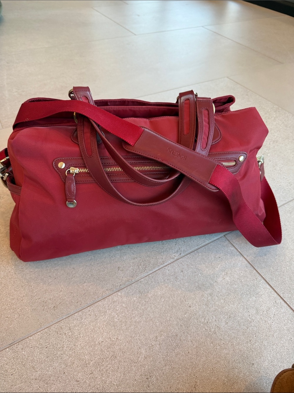 Tumi brick red Travel Duffel with Leather Trim and shoulder strap